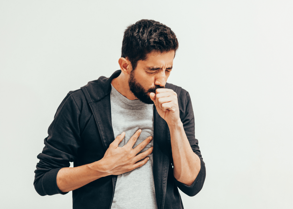Sick man coughing over his hand